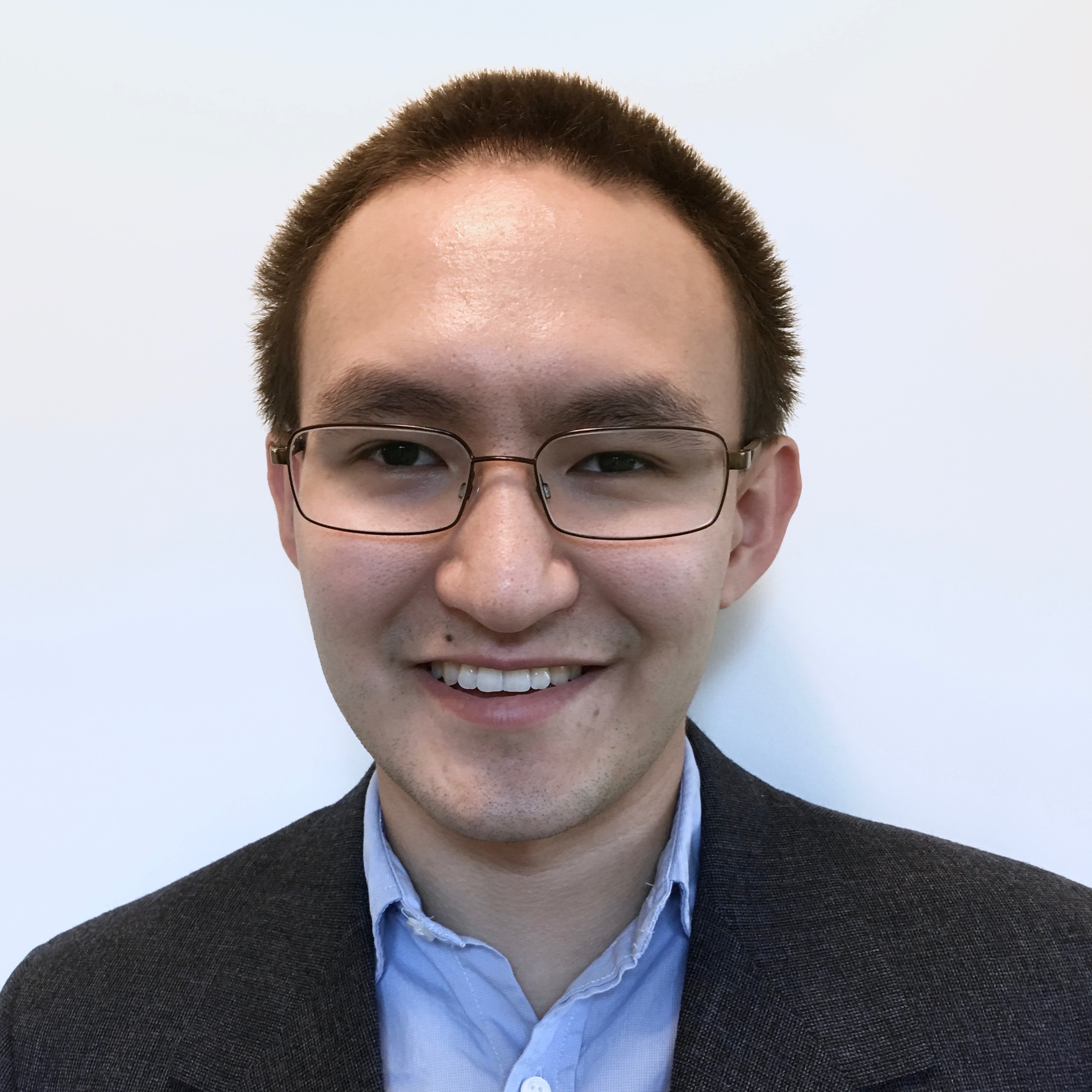 Takashi Inskeep, a geologist turned web developer, smiling at the camera